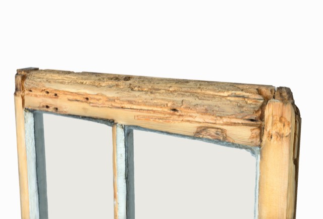 Rotten, decayed timber in a sash window rail before restoration